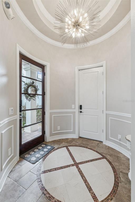 An open-concept living room features a staircase, kitchen, and dining area with tile flooring — 1172 CASTLE PINES CT, REUNION, FL