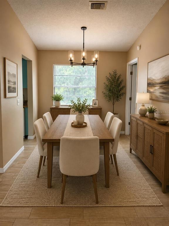 A dining room features a wooden table, six upholstered chairs, a chandelier, and a sideboard — 1726 MONTICELLO STREET, DELTONA, FL