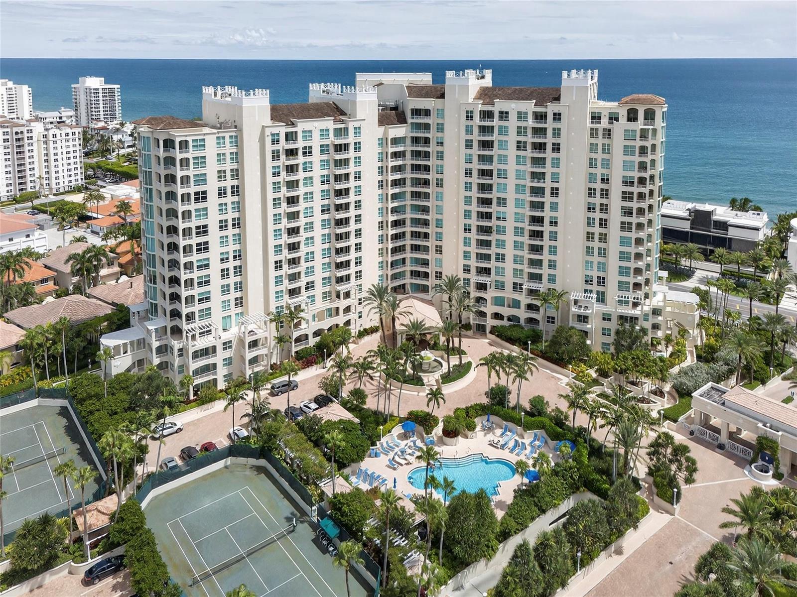 An aerial view shows a large residential building with a pool and tennis courts — 3700 S Ocean Boulevard # 308, Highland Beach FL 33487, HIGHLAND BEACH, FL