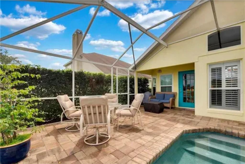 A screened-in patio features a small swimming pool, outdoor furniture, and a paved deck — 624 HARDWOOD CIRCLE, ORLANDO, FL