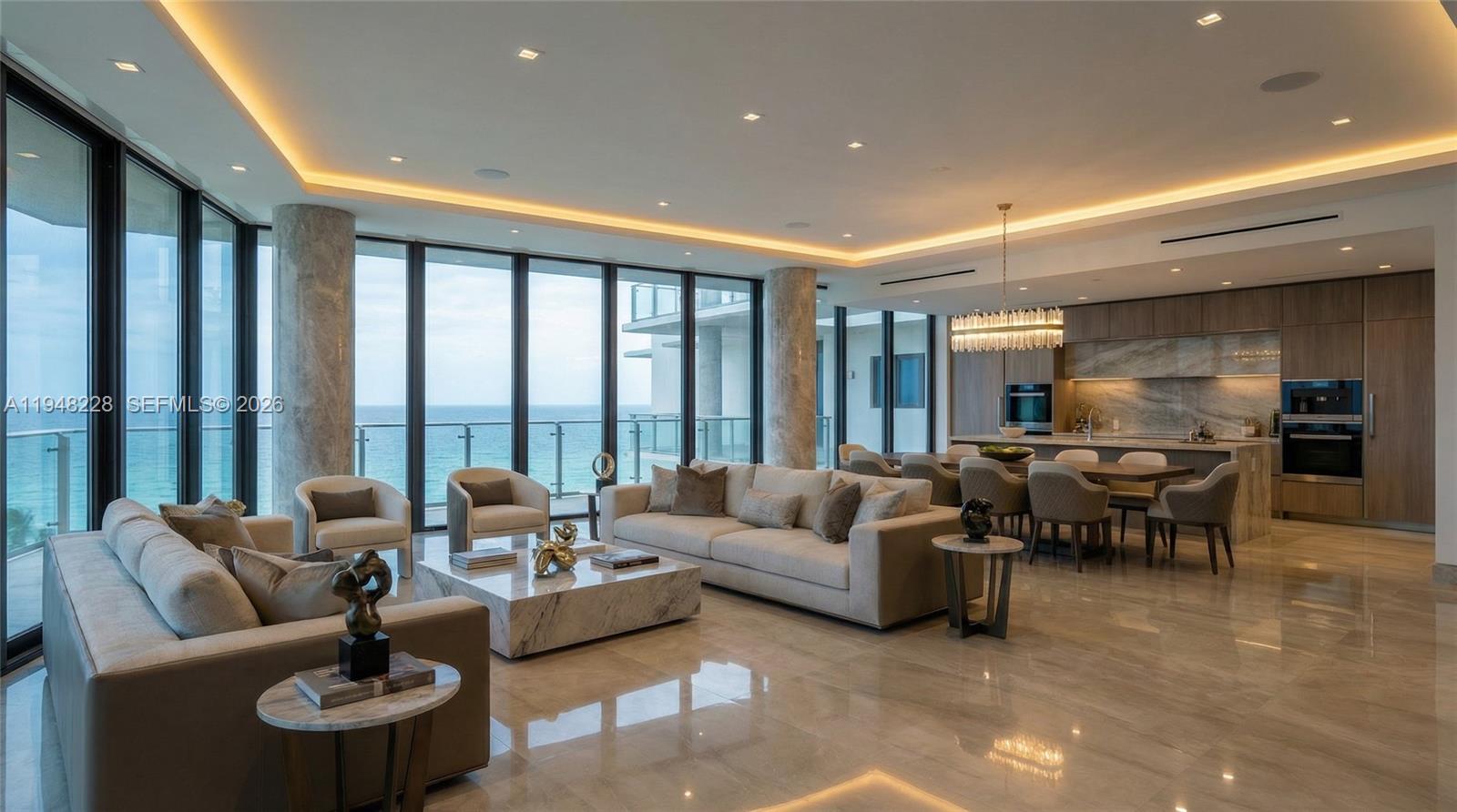 A modern open-concept living and dining area features marble floors, floor-to-ceiling windows, and ocean views — 3319 N Ocean Drive, Hollywood FL 33019, HOLLYWOOD, FL