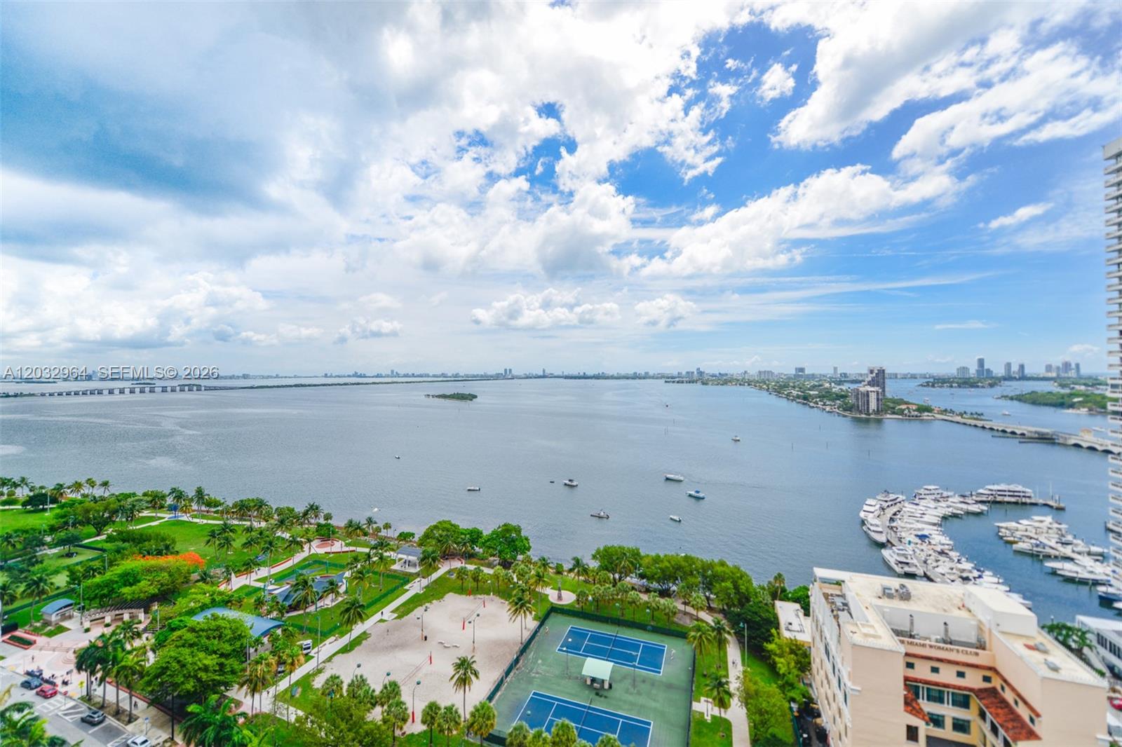 An elevated view of a park, tennis courts, a marina, and a large bay — 1750 N Bayshore Dr # 2402, Miami FL 33132, MIAMI, FL