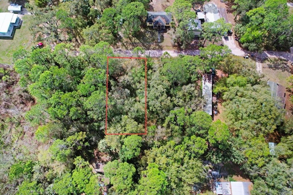 An aerial view shows a rectangular, tree-covered vacant lot outlined in red — 0 YUCATAN DRIVE, LAKE WALES, FL