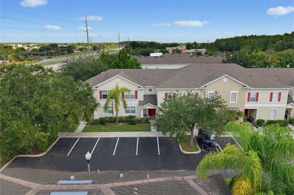 An elevated view of a two-story apartment building with a parking lot in front — 4997 TOWN TERRACE S, KISSIMMEE, FL