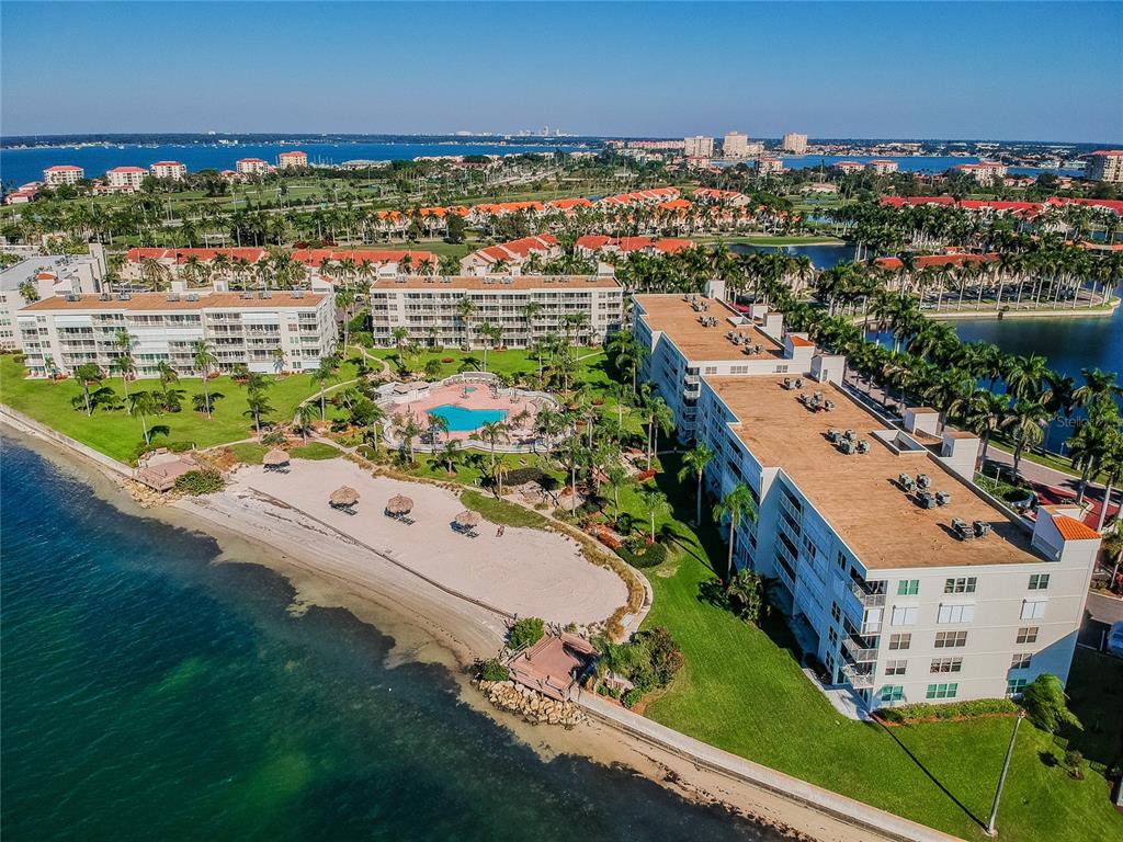 An aerial view of a waterfront apartment complex with a pool, beach, and palm trees — 6061 BAHIA DEL MAR CIRCLE UNIT 347, ST PETERSBURG, FL