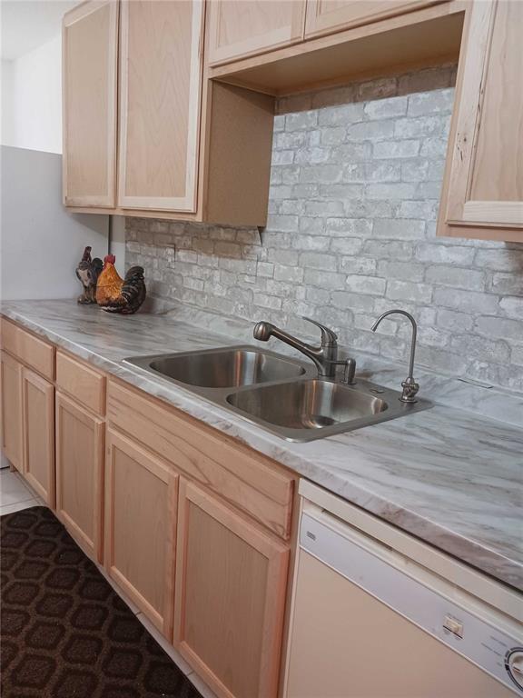 A kitchen features light wood cabinets, a faux-brick backsplash, and a double-basin stainless steel sink — 2901 NW 48TH AVENUE UNIT 367, LAUDERDALE LAKES, FL