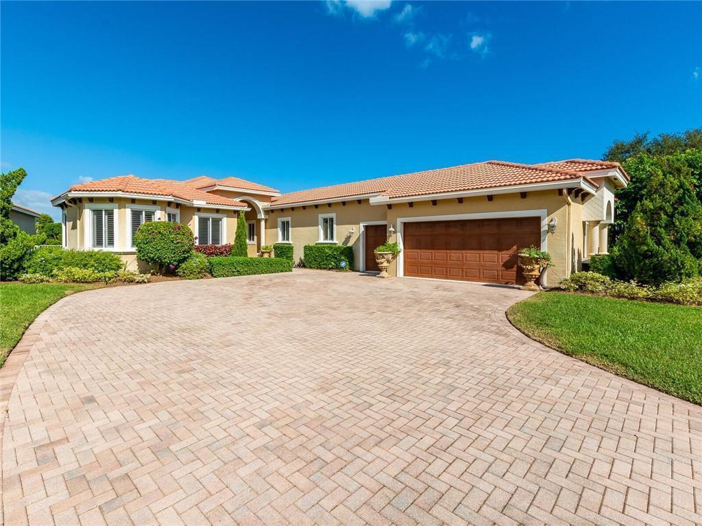 A single-story house with a tiled roof, beige stucco exterior, and a paved driveway — 775 Greensward Lane, Delray Beach FL 33445, DELRAY BEACH, FL