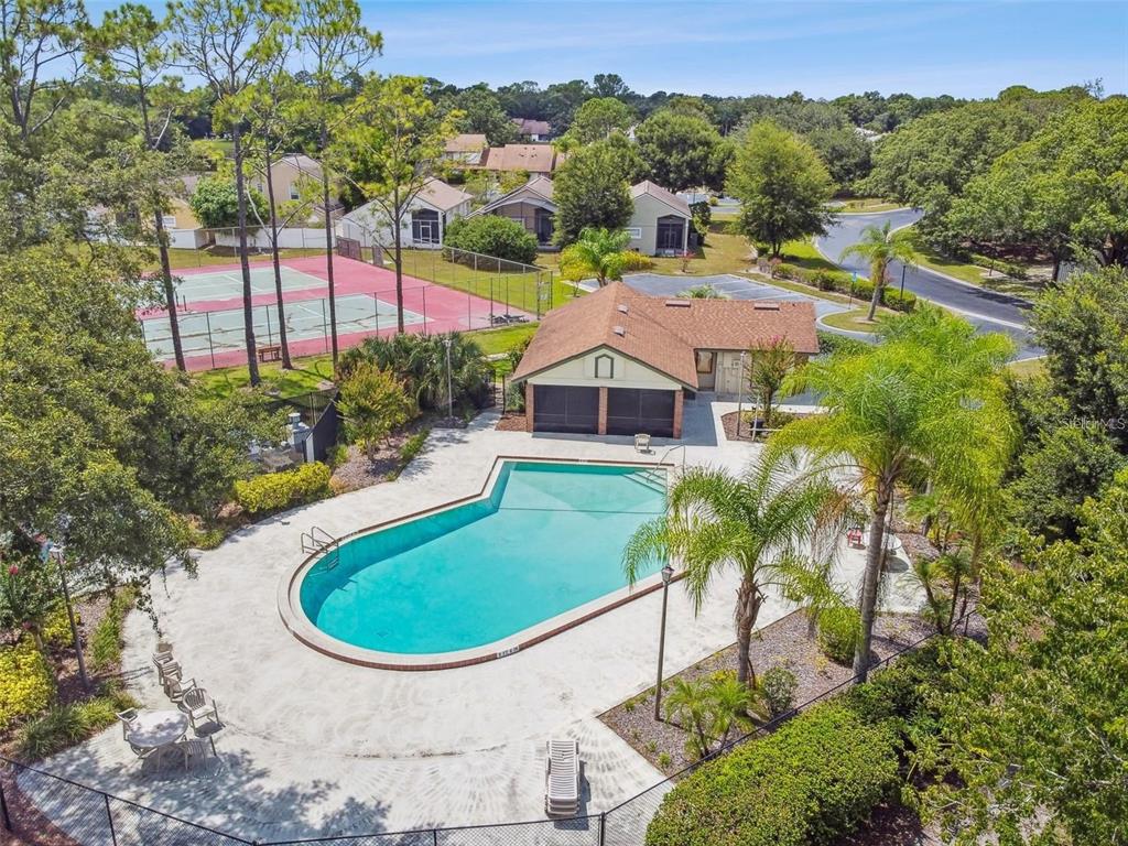 An aerial view of a community swimming pool, tennis courts, and a clubhouse building — 4008 W MARYLAND PLACE, CASSELBERRY, FL