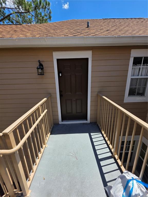 A brown exterior door is accessed by a walkway with tan railings — 705 YOUNGSTOWN PARKWAY UNIT 356, ALTAMONTE SPRINGS, FL