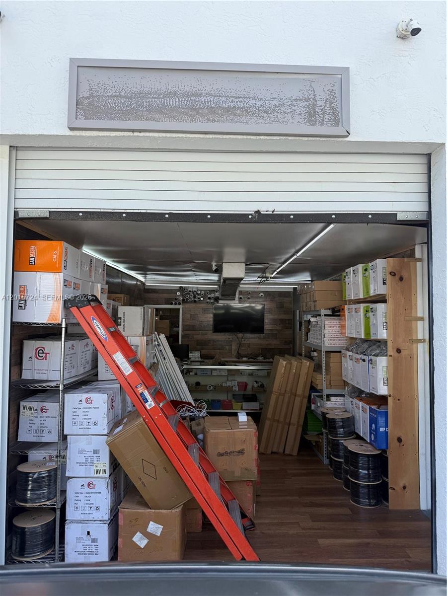 A storage unit or small warehouse space filled with boxes of cables and shelving units — 1775 Blount Rd # 410, Pompano Beach FL 33069, POMPANO BEACH, FL