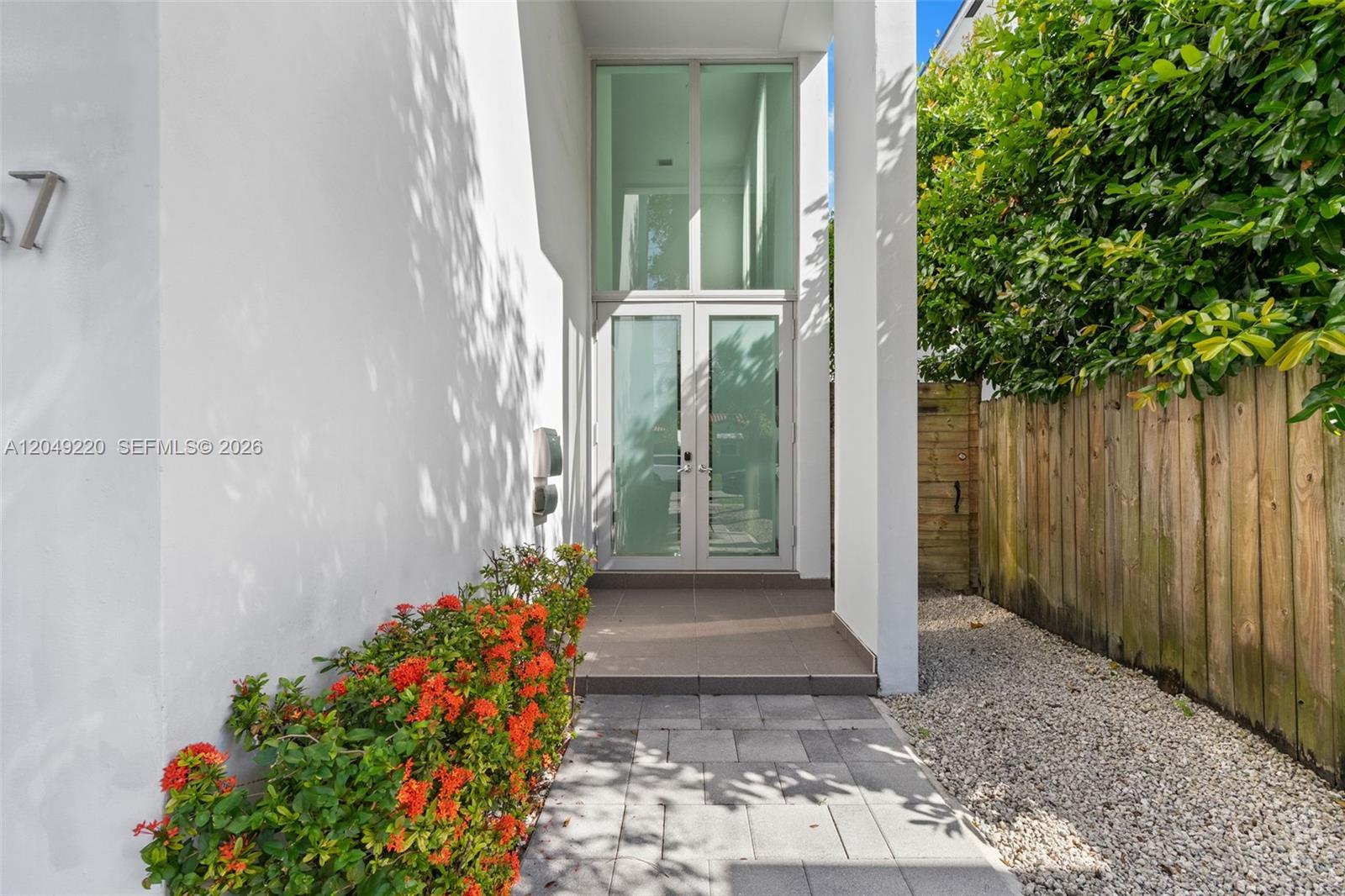 A modern entryway features a glass double door, white walls, and a paved walkway — 3567 SW 1st Ave # 3567, Miami FL 33145, MIAMI, FL