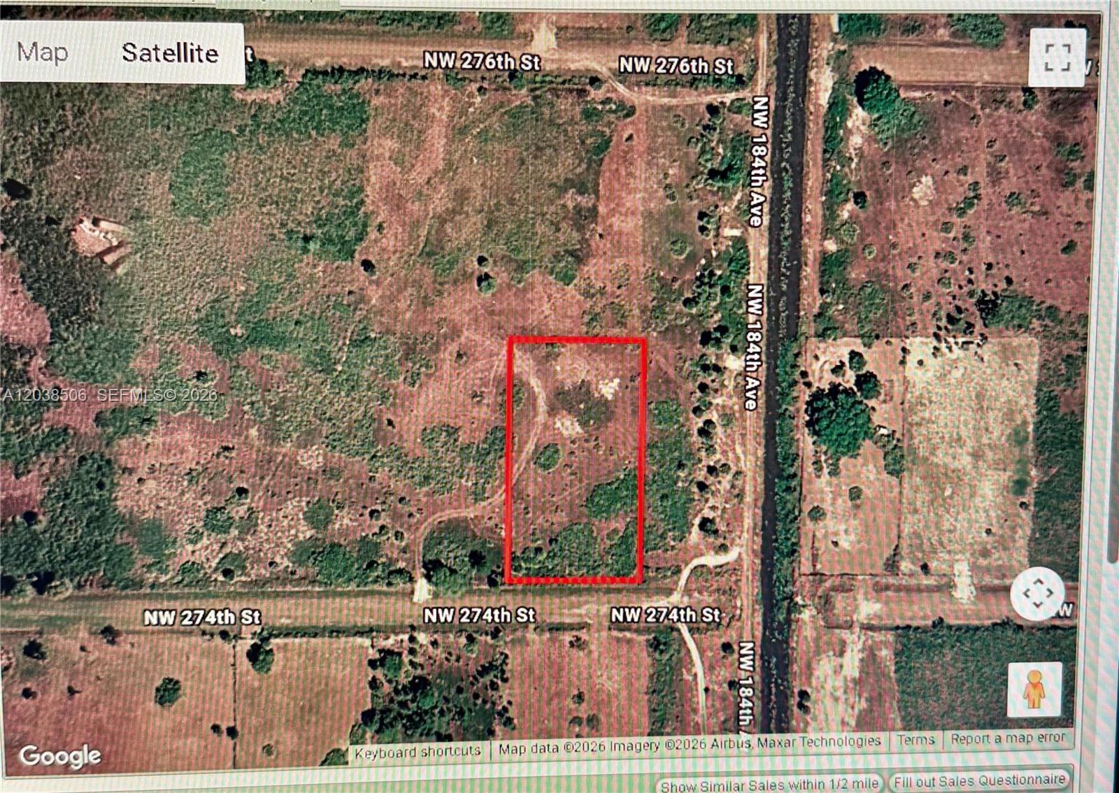 This is a satellite map view showing a rectangular plot of land outlined in red — 18457 NW 274th ST, Okeechobee FL 34972, OKEECHOBEE, FL
