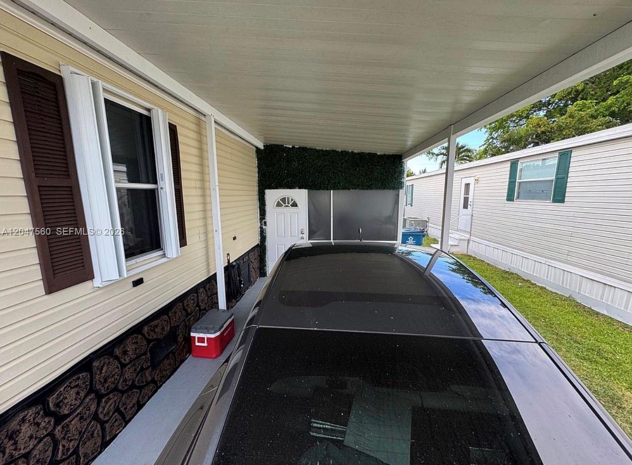 A car is parked under a carport attached to a light-colored mobile home — 1196 SW 112th way, Davie FL 33325, DAVIE, FL