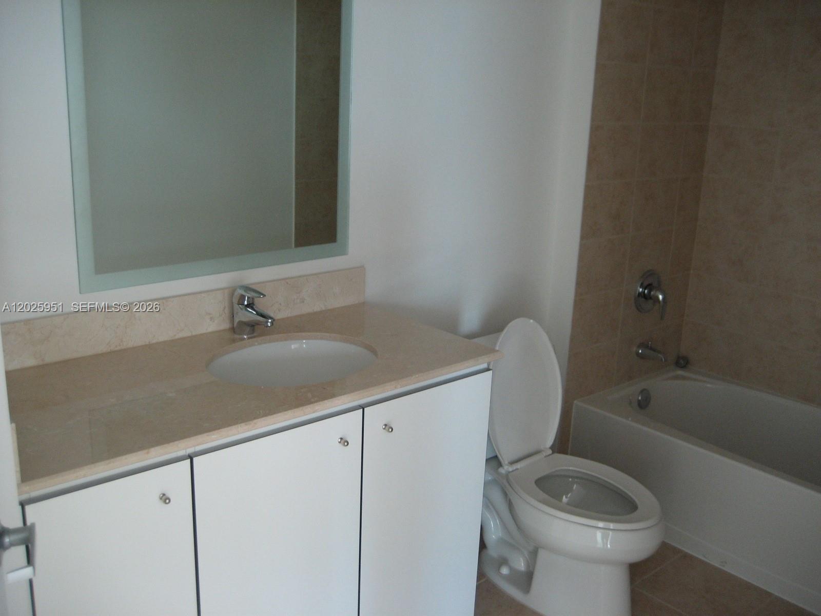 A bathroom features a white vanity with a beige countertop, a toilet, and a bathtub — 9066 SW 73 CT # 1802, Miami FL 33156, MIAMI, FL