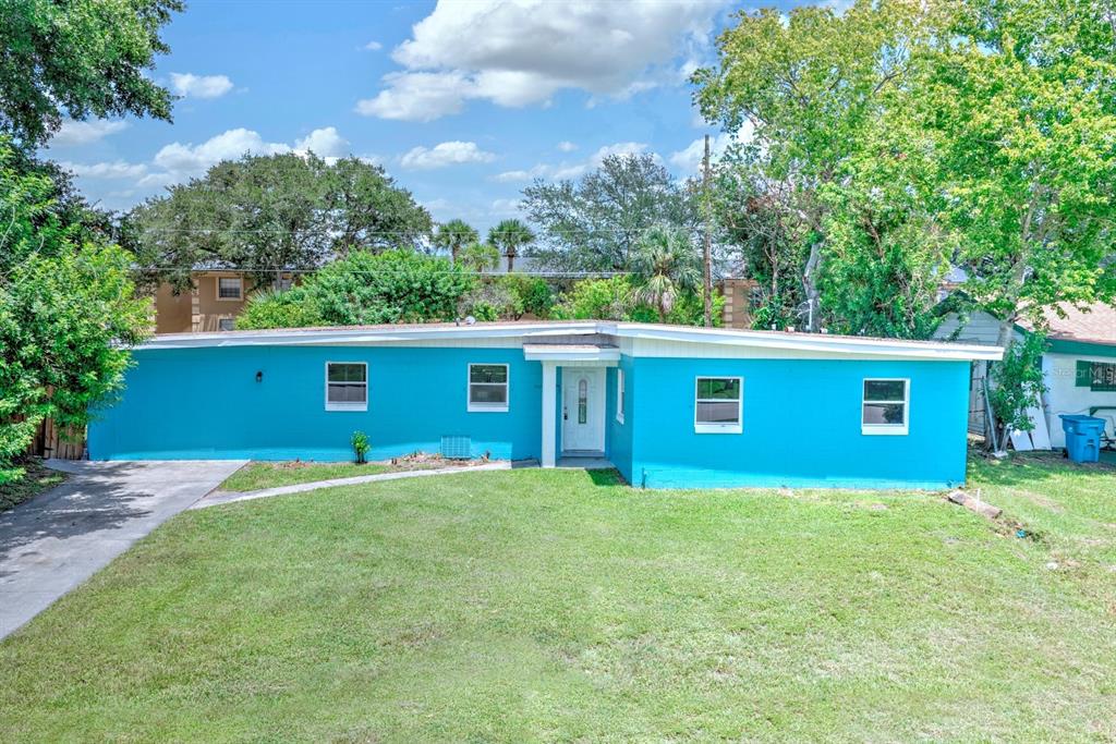 A single-story, bright blue house with a flat roof and a front-facing entrance — 3009 MARATHON AVENUE, ORLANDO, FL