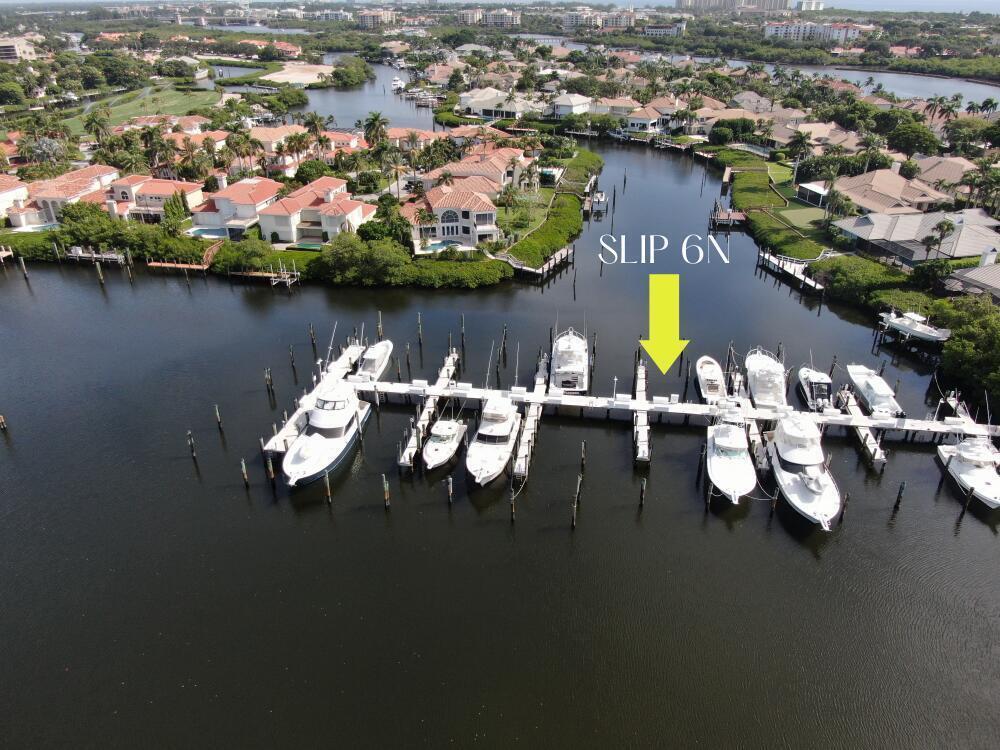 An aerial view of a boat dock with multiple yachts moored in a residential canal — 3232 Casseekey Island Road, Jupiter FL 33477, JUPITER, FL
