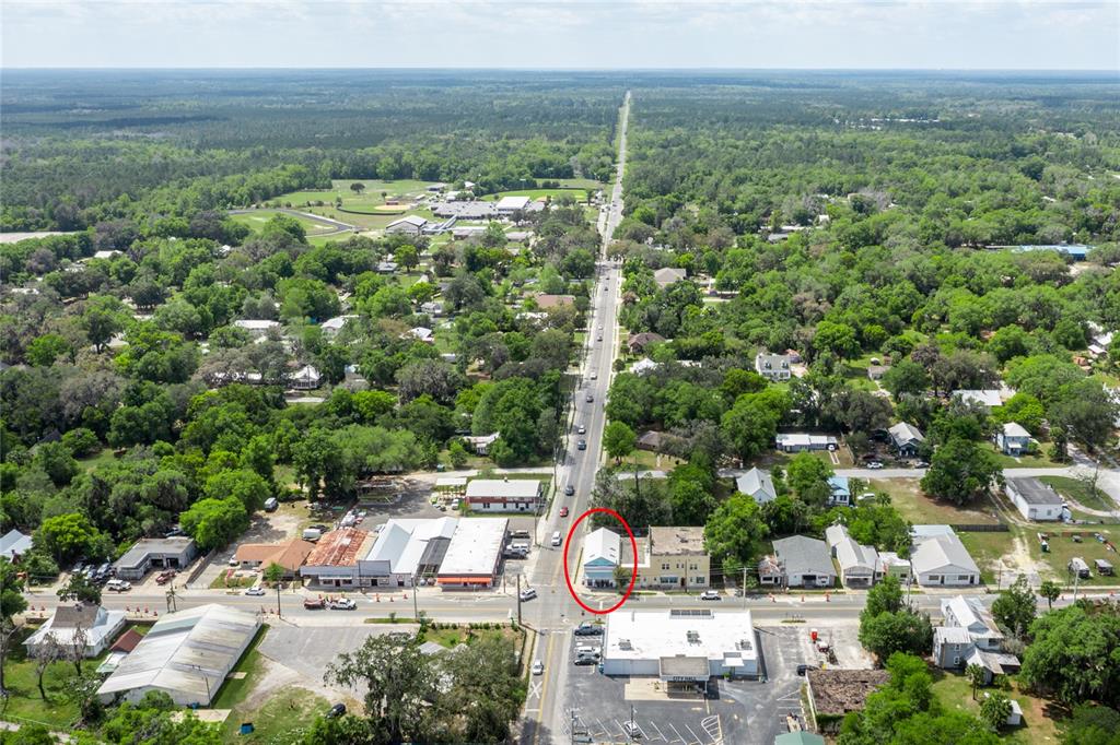 An aerial view shows a small town with a circled building along a main road — 6880 SE 221ST STREET, HAWTHORNE, FL