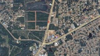 An aerial view showing a highway intersection, surrounding residential areas, and undeveloped land — COMMERCIAL WAY, WEEKI WACHEE, FL