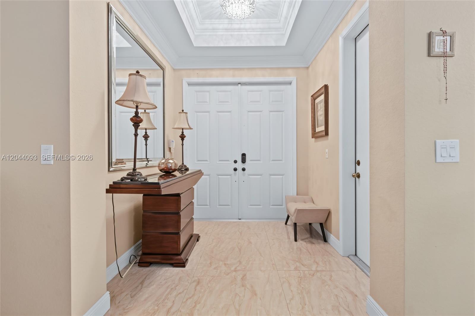 A foyer features a tray ceiling, tile flooring, a wooden console table, and double doors — 4200 Key Lime Blvd, Boynton Beach FL 33436, BOYNTON BEACH, FL