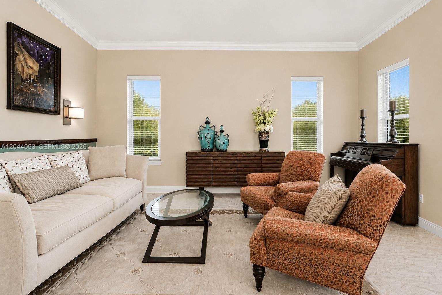 A living room features a beige sofa, two patterned armchairs, a glass coffee table, and piano — 4200 Key Lime Blvd, Boynton Beach FL 33436, BOYNTON BEACH, FL