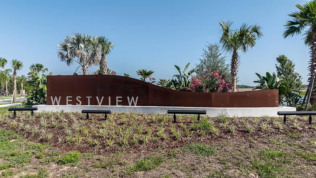 A metal Westview community sign sits on a concrete base surrounded by landscaping and palms — 5470 CROWN POINT ROAD, KISSIMMEE, FL