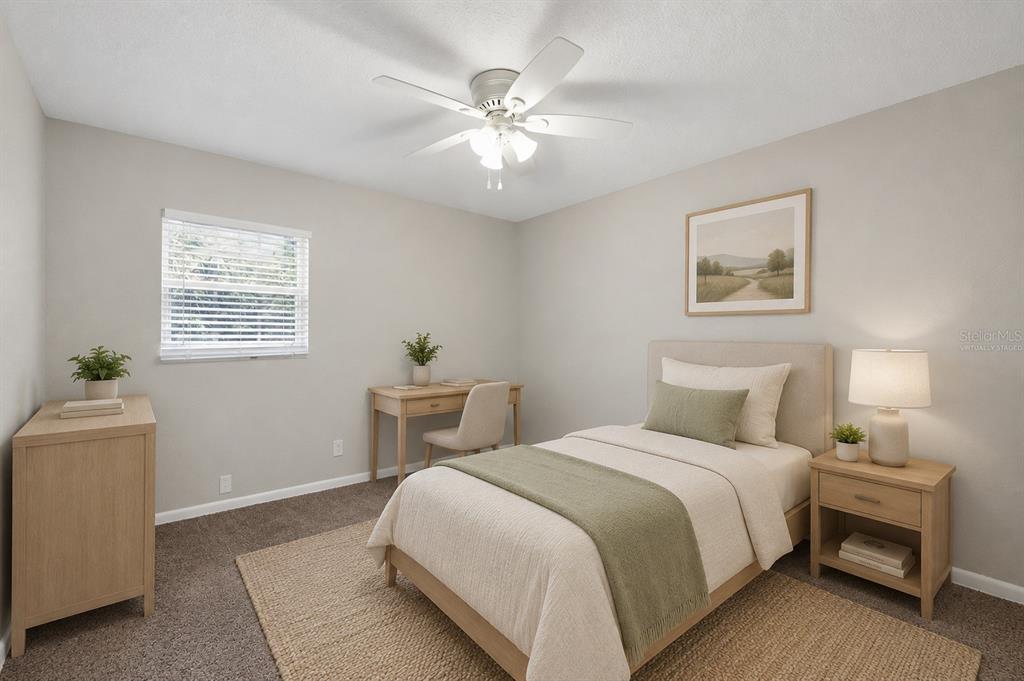 A virtually staged bedroom features a bed, desk, dresser, and a ceiling fan — 3519 COLLEGE STREET, JACKSONVILLE, FL