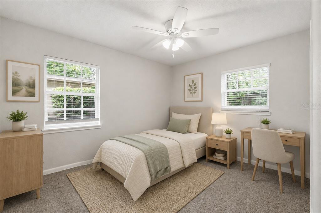 A bedroom features a twin bed, a desk, a nightstand, and a ceiling fan — 3519 COLLEGE STREET, JACKSONVILLE, FL