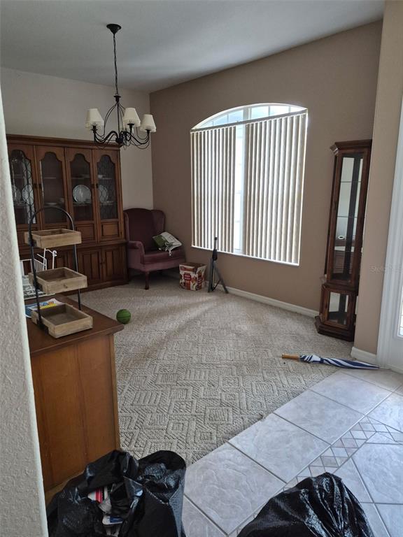 A dining room features a large hutch, a corner display cabinet, and a window with blinds — 3163 FOREST CREEK DRIVE, MELBOURNE, FL