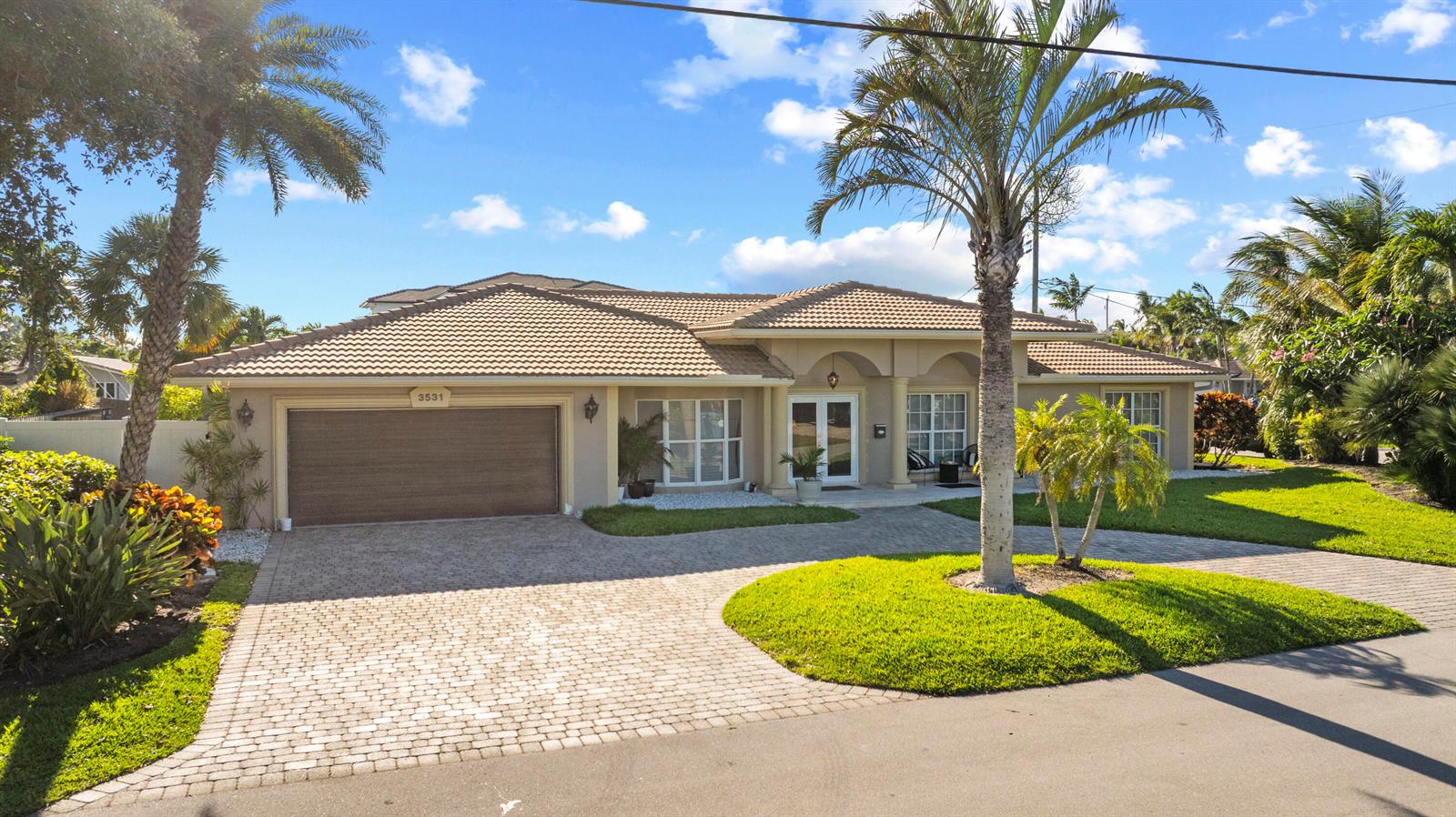 A single-story house with a beige exterior, a tiled roof, and a paved driveway — 3531 NE 30th Avenue, Lighthouse Point FL 33064, LIGHTHOUSE POINT, FL