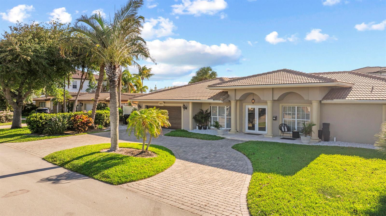 A single-story house with a paved driveway, palm trees, and a tiled roof — 3531 NE 30th Avenue, Lighthouse Point FL 33064, LIGHTHOUSE POINT, FL