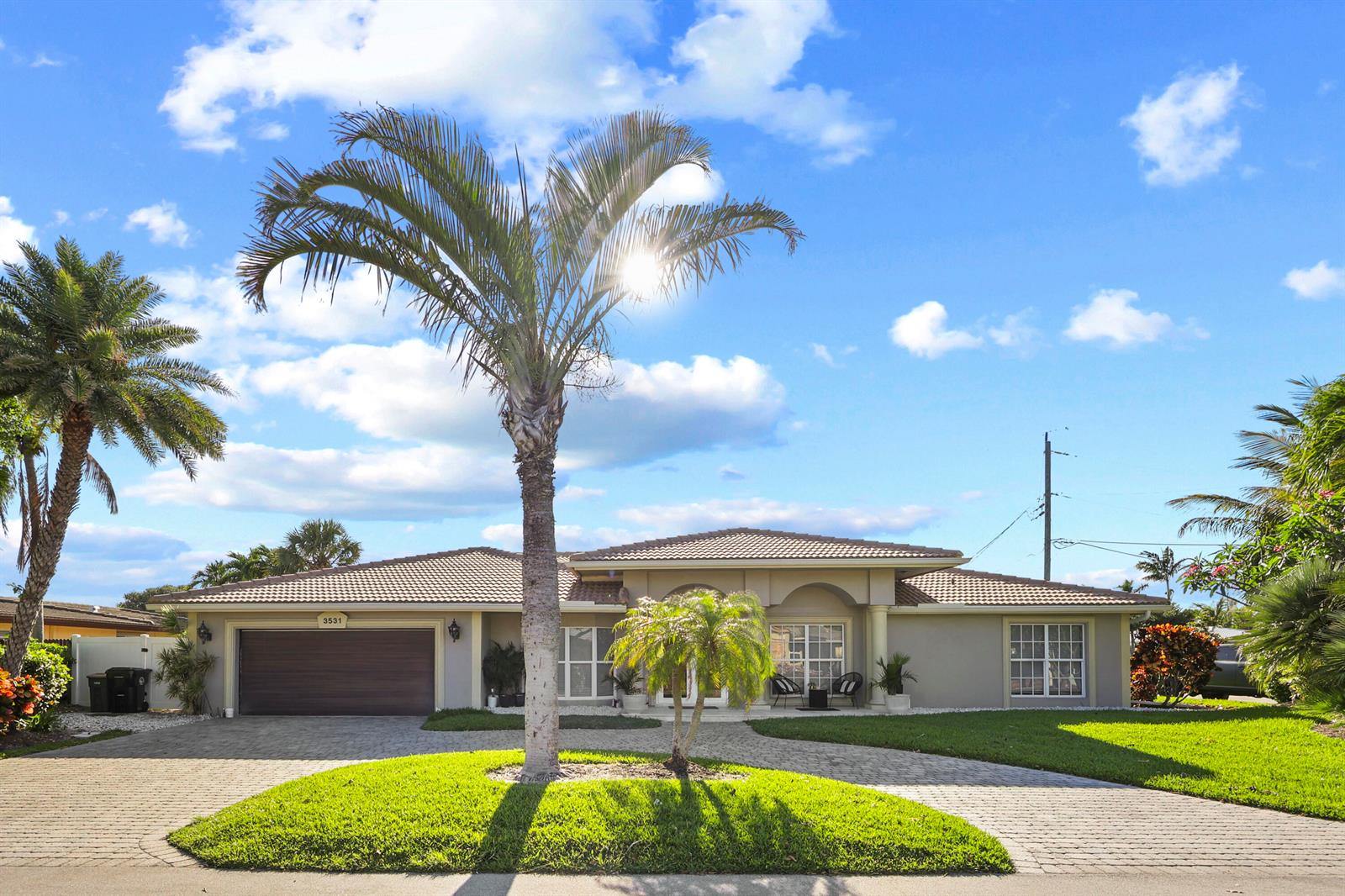 A single-story house with a paved driveway, palm trees, and a two-car garage — 3531 NE 30th Avenue, Lighthouse Point FL 33064, LIGHTHOUSE POINT, FL
