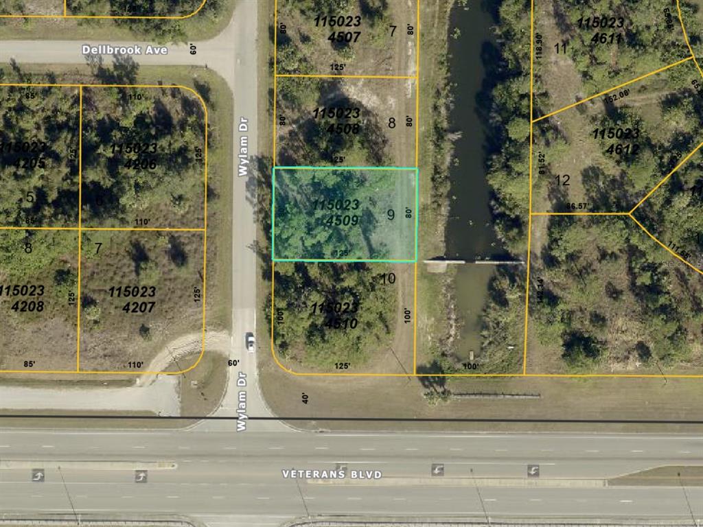 This is a map showing a highlighted vacant lot located between a road and a canal — 0 WYLAM DRIVE, NORTH PORT, FL
