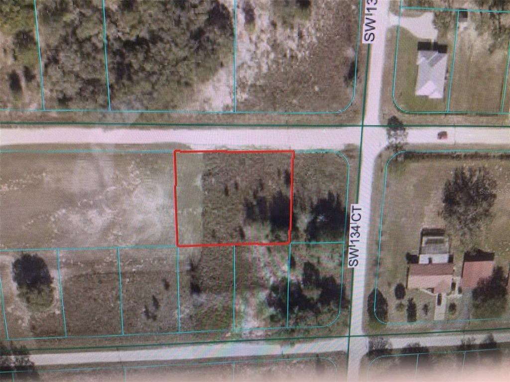 This is an aerial map showing a vacant rectangular lot outlined in red — 0 SW 107 STREET, DUNNELLON, FL