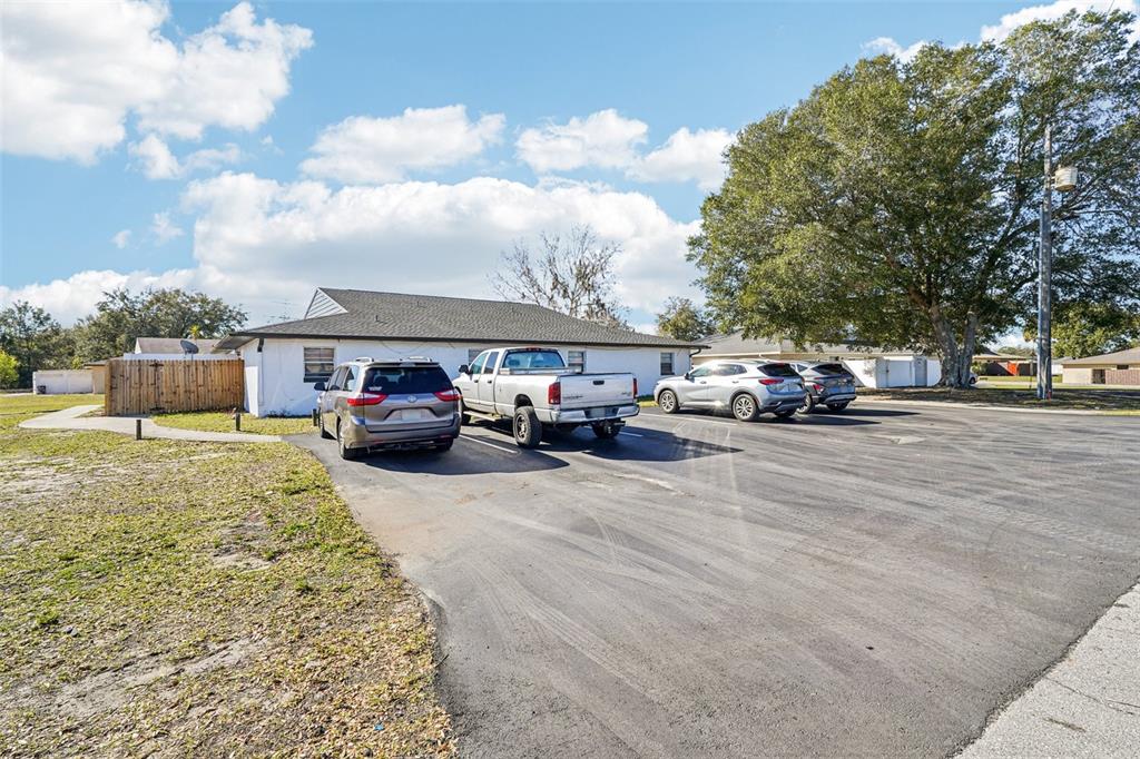 A white single-story building with a parking lot and several parked vehicles — 5080 SE 31ST STREET, OCALA, FL