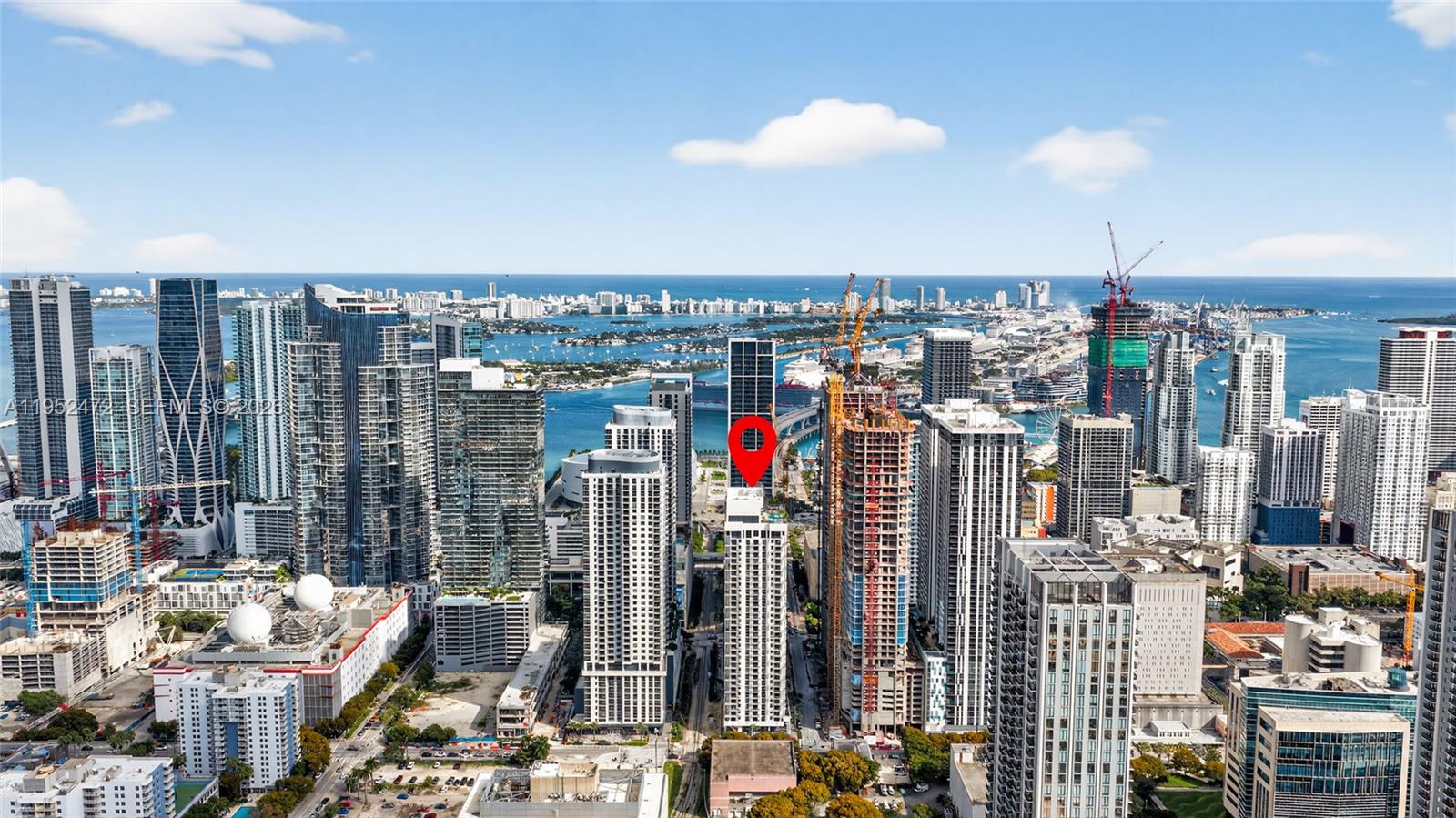 An aerial view of a dense urban skyline featuring numerous high-rise buildings near the coast — 11 NE 6 ST # 3210, Miami FL 33132, MIAMI, FL