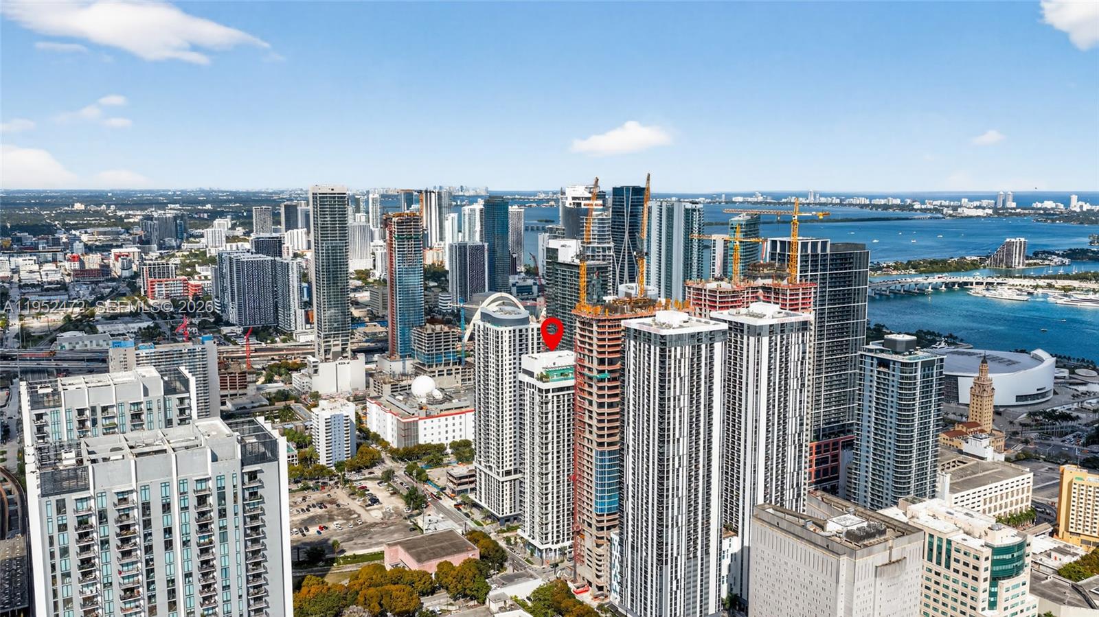 An aerial view shows a dense urban skyline with multiple high-rise buildings and construction sites — 11 NE 6 ST # 3210, Miami FL 33132, MIAMI, FL
