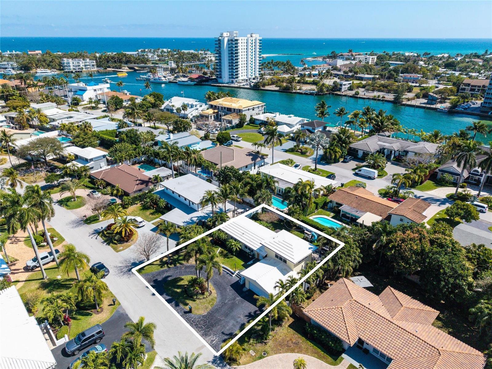 An aerial view of a single-story house with a circular driveway and a white roof — 2630 NE 25th Street, Lighthouse Point FL 33064, LIGHTHOUSE POINT, FL