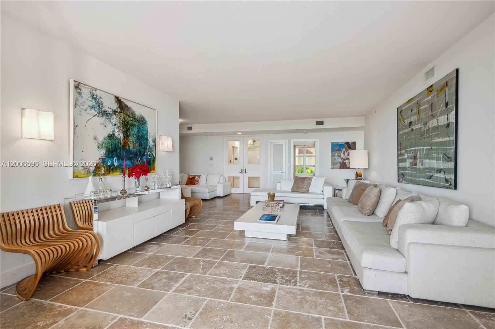 A spacious living room features white sofas, a low coffee table, and large abstract wall art — 747 Crandon Blvd, Key Biscayne FL 33149, KEY BISCAYNE, FL