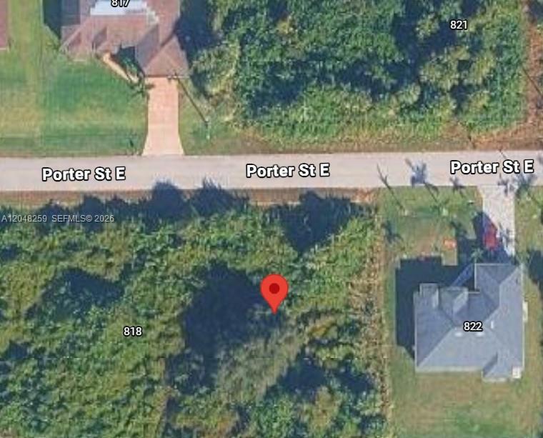 This is an aerial map view of a vacant lot marked with a red pin — 820 Porter ST E, Lehigh Acres FL 33974, LEHIGH ACRES, FL