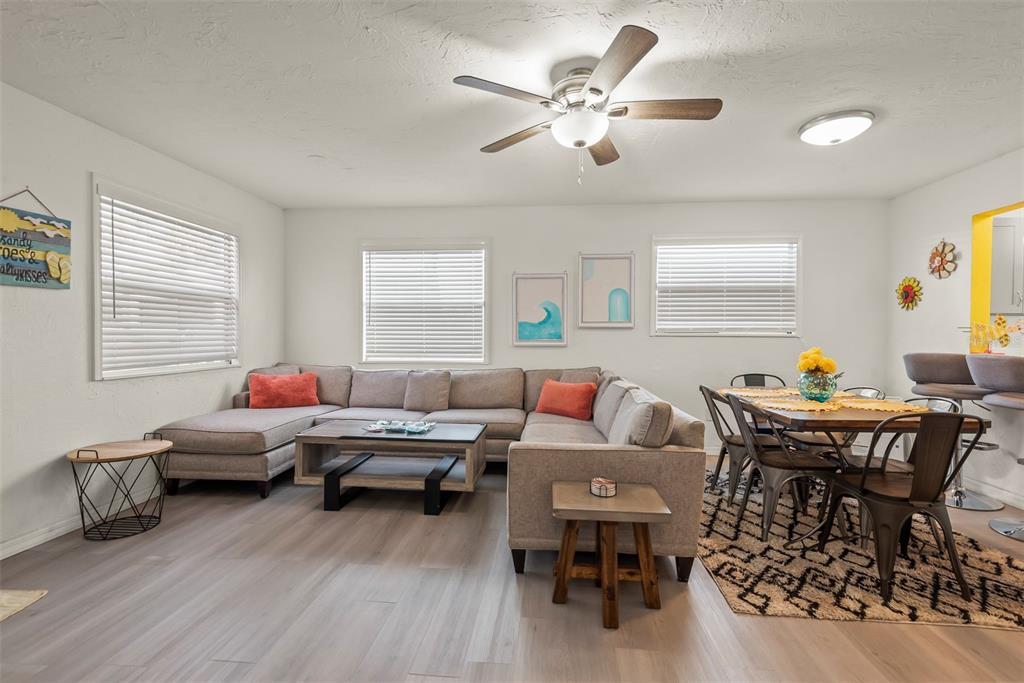 A living and dining area features a sectional sofa, wood-look flooring, and a ceiling fan — 5125 ISABELLE AVENUE, PORT ORANGE, FL
