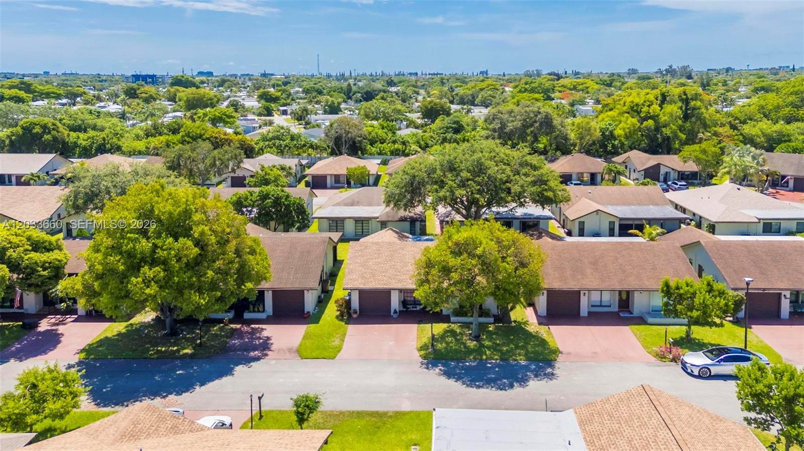 An aerial view shows several single-story residential buildings with brown roofs and paved driveways — 1726 SW 20th Ter, Deerfield Beach FL 33442, DEERFIELD BEACH, FL