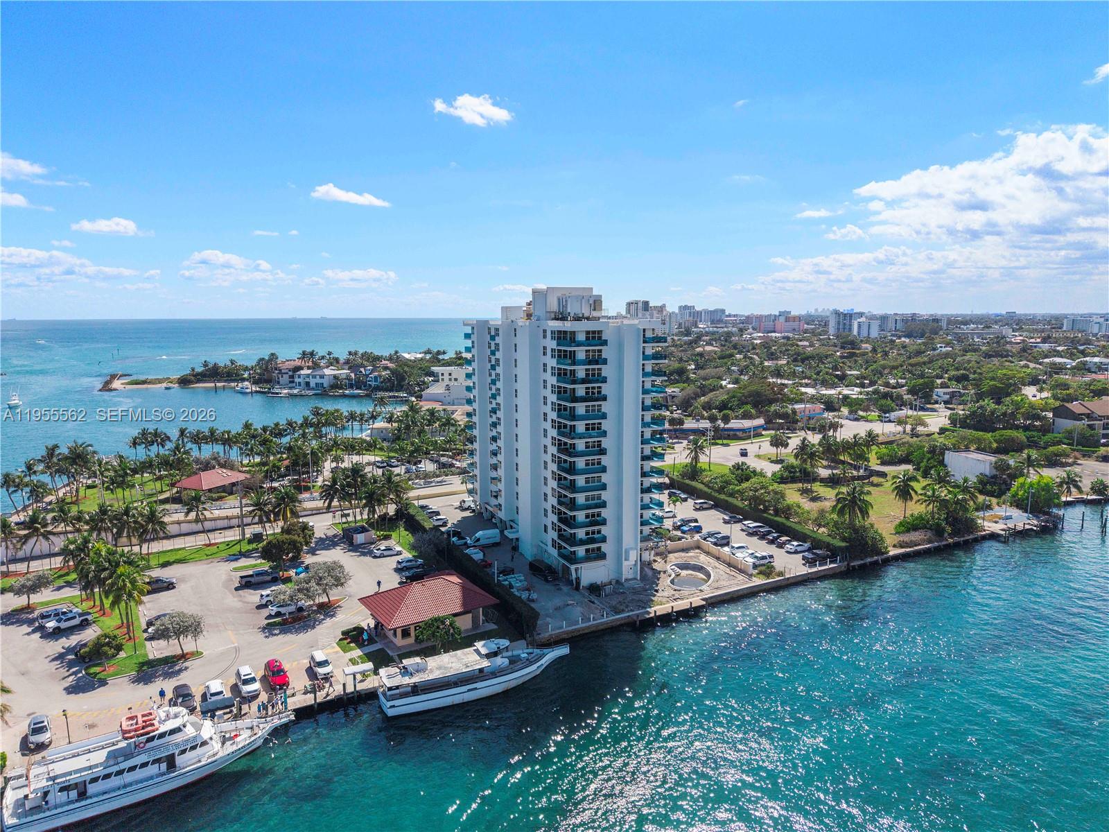 An aerial view shows a tall residential building situated on a waterfront property with boats — 2639 N Riverside Dr # 806, Pompano Beach FL 33062, POMPANO BEACH, FL