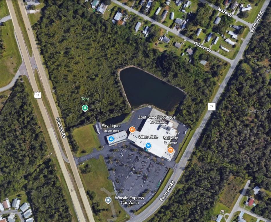 This aerial map shows a commercial shopping center with a parking lot and adjacent pond — 27750 BERMONT ROAD, PUNTA GORDA, FL