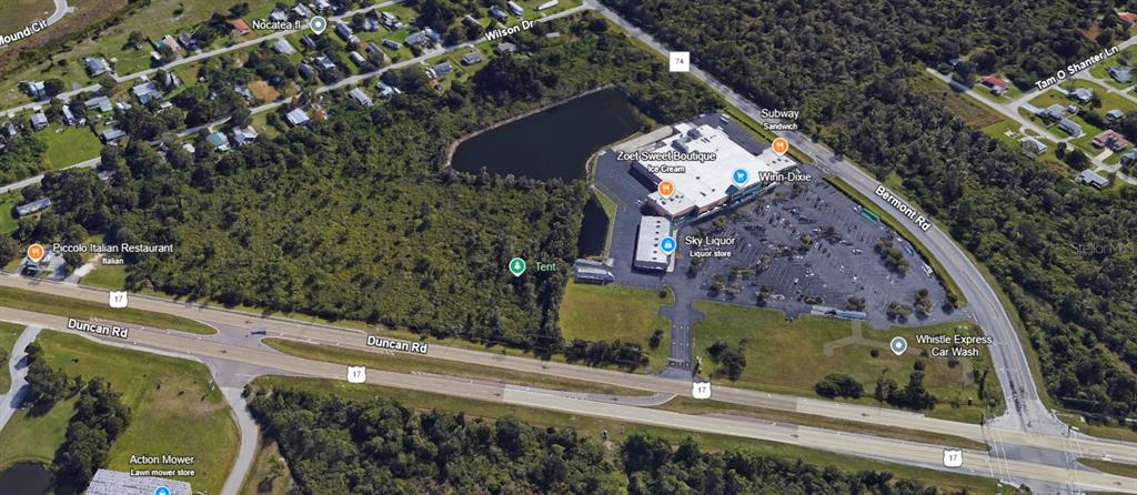 This aerial map shows a commercial shopping center with a parking lot near a highway — 27750 BERMONT ROAD, PUNTA GORDA, FL