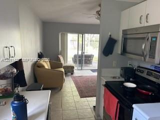 An aerial view shows a house with a tiled roof and a screened-in patio — 450 SE 30th Dr, Homestead FL 33033, HOMESTEAD, FL