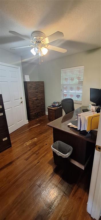 A home office features a wooden desk, a ceiling fan, and hardwood flooring — 360 TANGERINE AVENUE, MERRITT ISLAND, FL