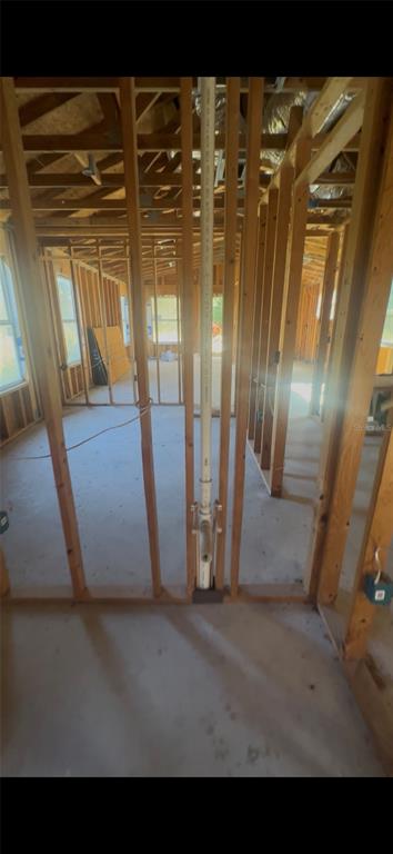 An interior view of a house under construction showing wooden wall studs and plumbing pipes — 15098 NE 35TH AVENUE ROAD, CITRA, FL