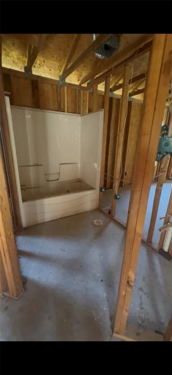 An unfinished bathroom featuring a white tub and shower surround framed by exposed wooden studs — 15098 NE 35TH AVENUE ROAD, CITRA, FL