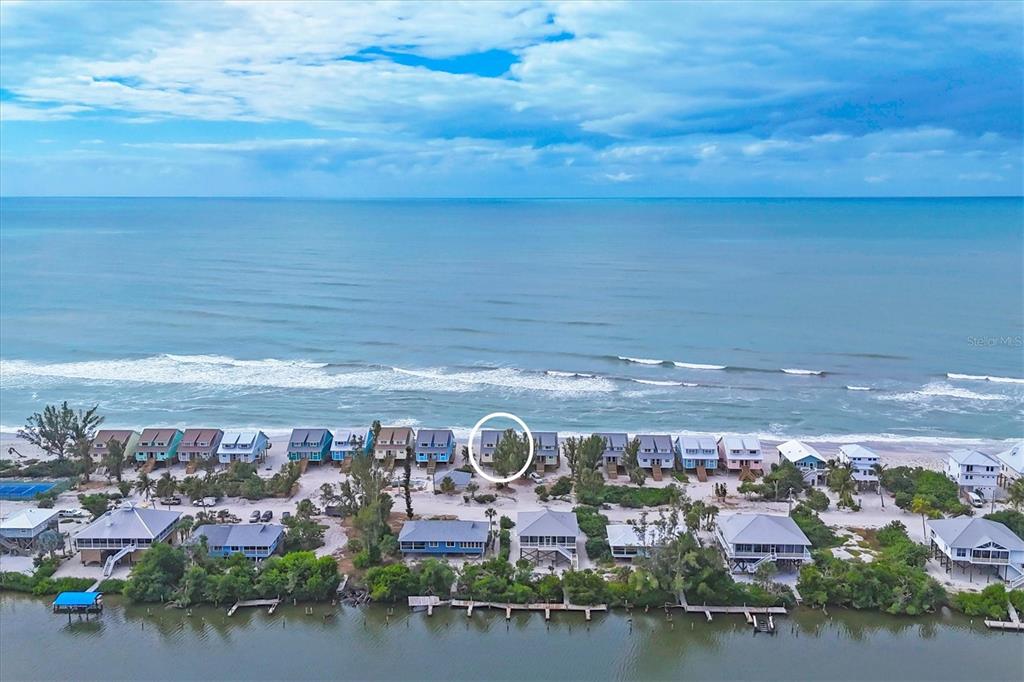 An aerial view shows a row of beach houses along the coast with a circled property — 301 S GULF BOULEVARD UNIT 12, PLACIDA, FL