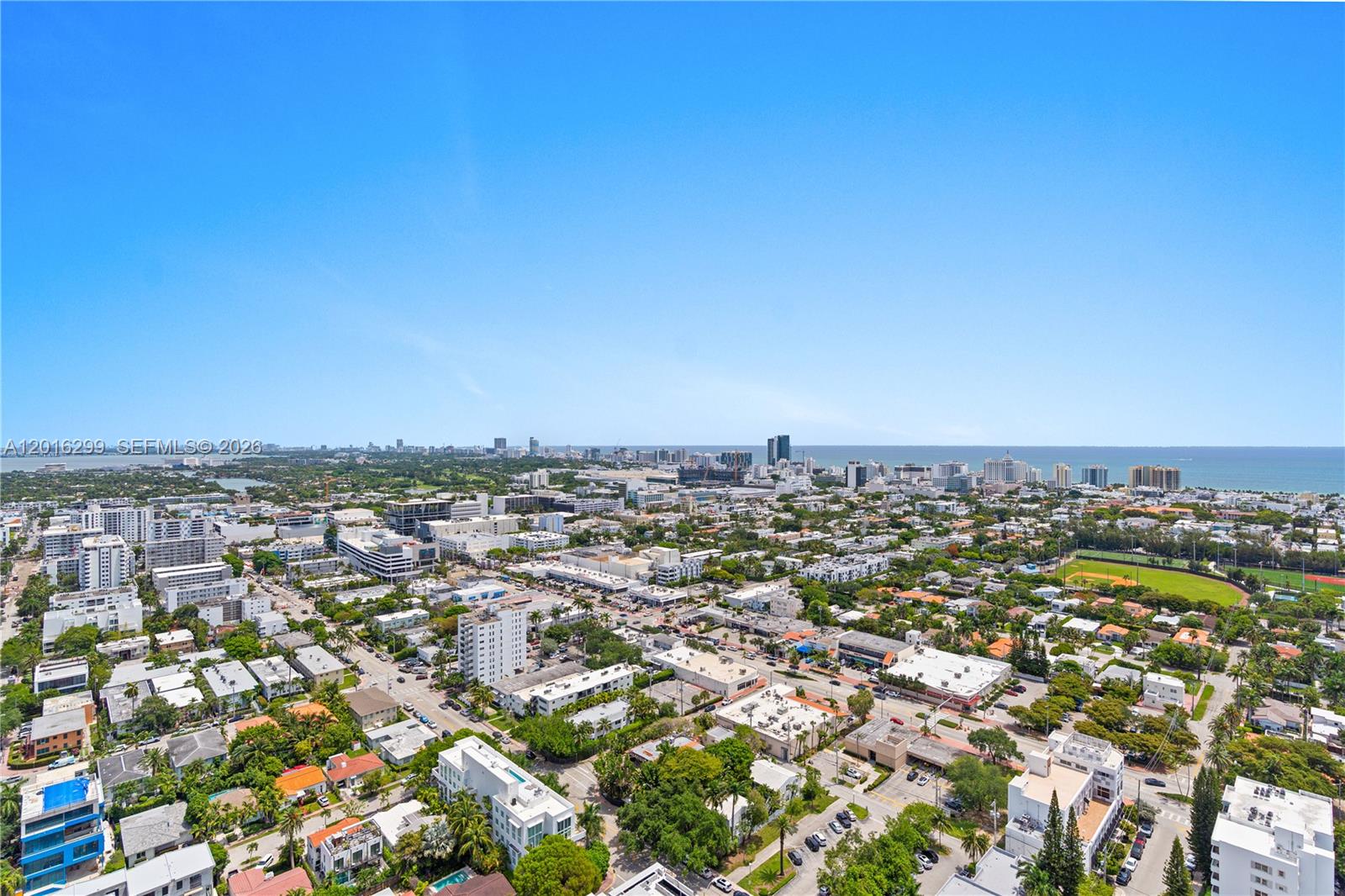 An elevated view shows a coastal city with buildings, trees, and the ocean in distance — 1330 West Ave, Miami Beach FL 33139, MIAMI BEACH, FL
